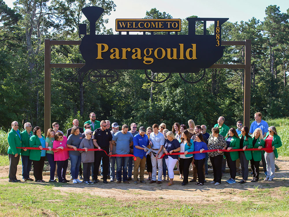 A ribbon cutting for the Welcome to Paragould Sign.