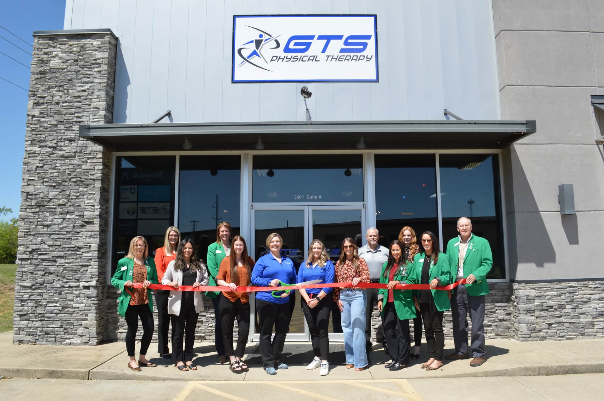 GTS Physical Therapy sign above a ribbon cutting taking place by the Paragould Regional Chamber of Commerce