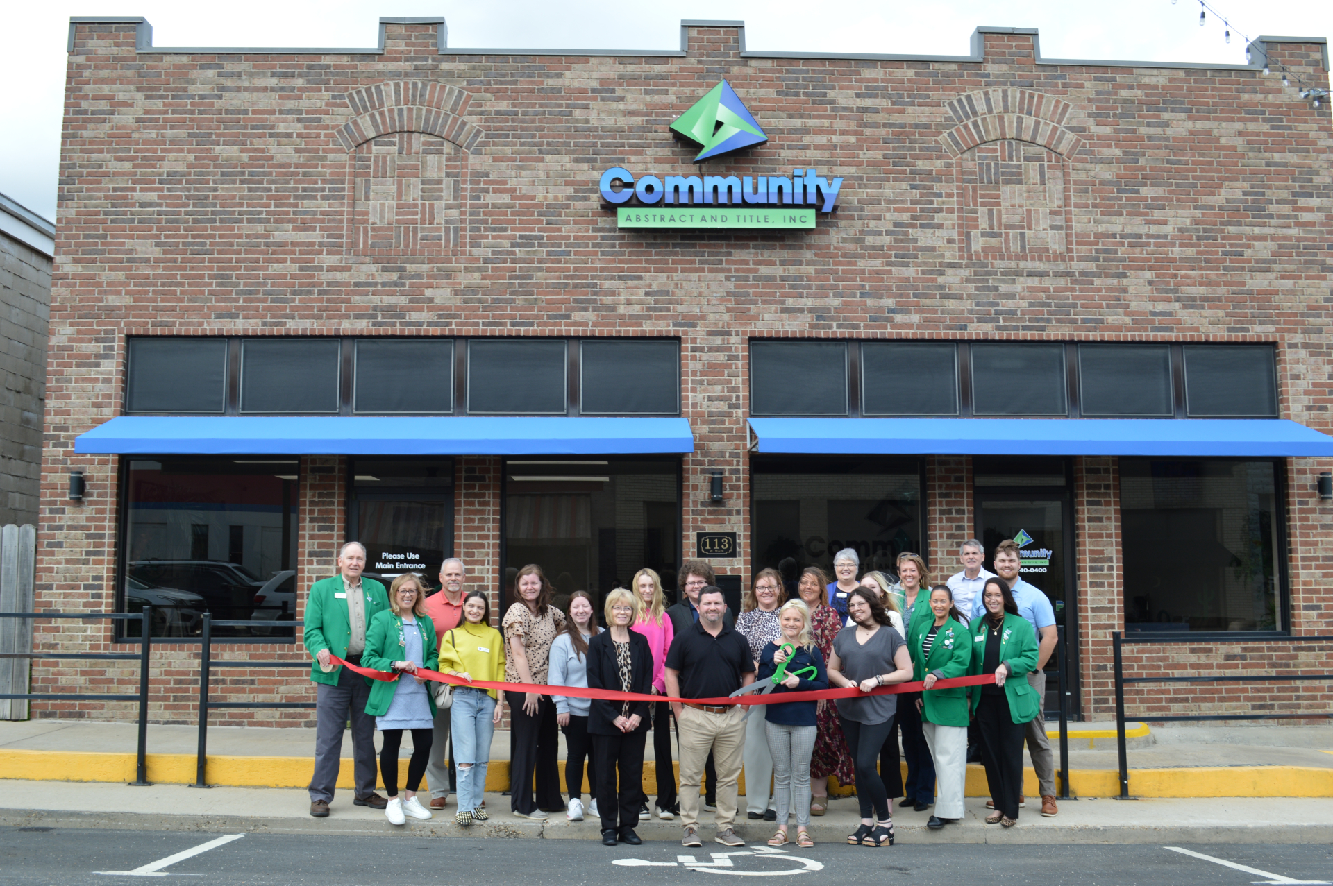 Community Abstract & Title Cuts a Ribbon!